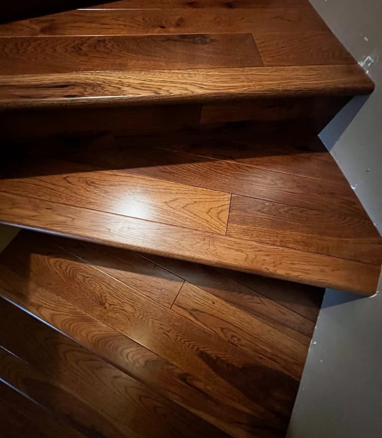 Close-up of dark hardwood treads on a turning staircase