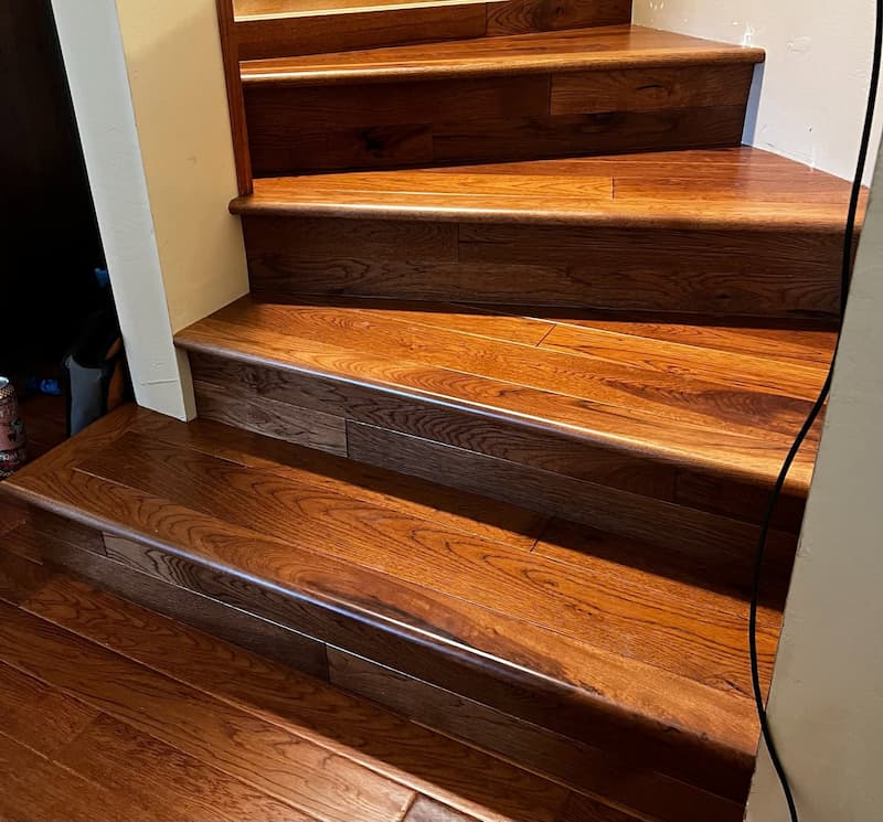 Finished hardwood staircase with matching wood risers